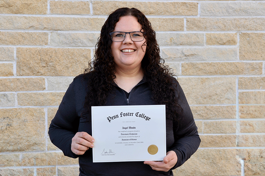 Angel Woods shows her Penn Foster completion certificate.